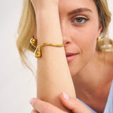 Model wearing a chunky organic shaped bangle 