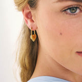 Heart shaped drop earrings on a model