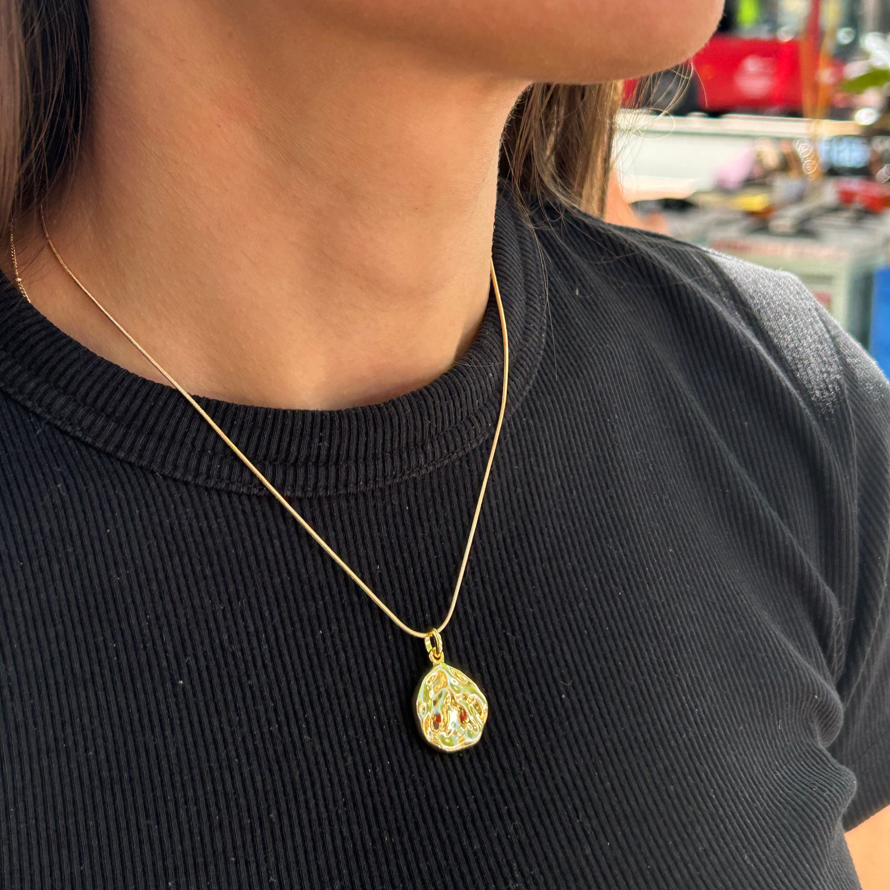 Girl modelling our Ripple pendant necklace in gold,vermeil