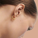 Close up of new classic Maribo gold hoops on models ear