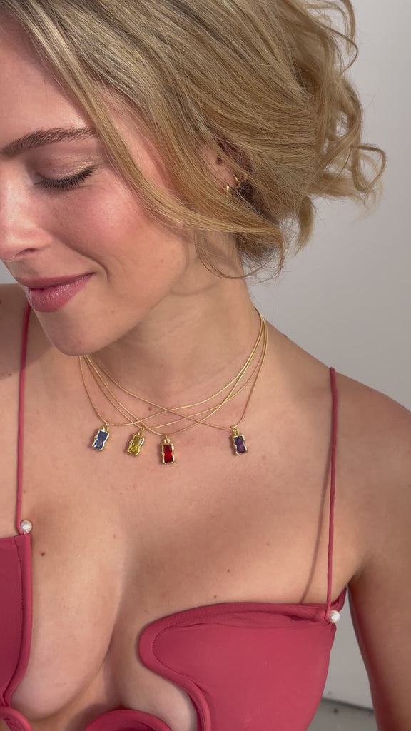 Video of model in bright coloured large gemstone pendant