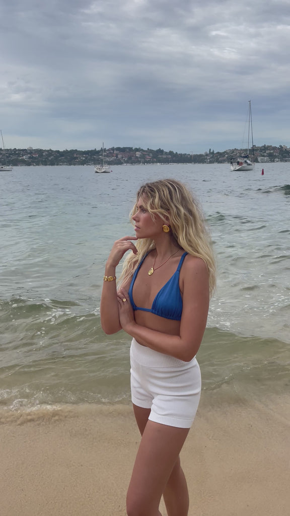 video of Bixby model by the sea in our waterproof earrings and necklace