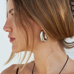 Model in Bixby and co silver Kahlo earrings 