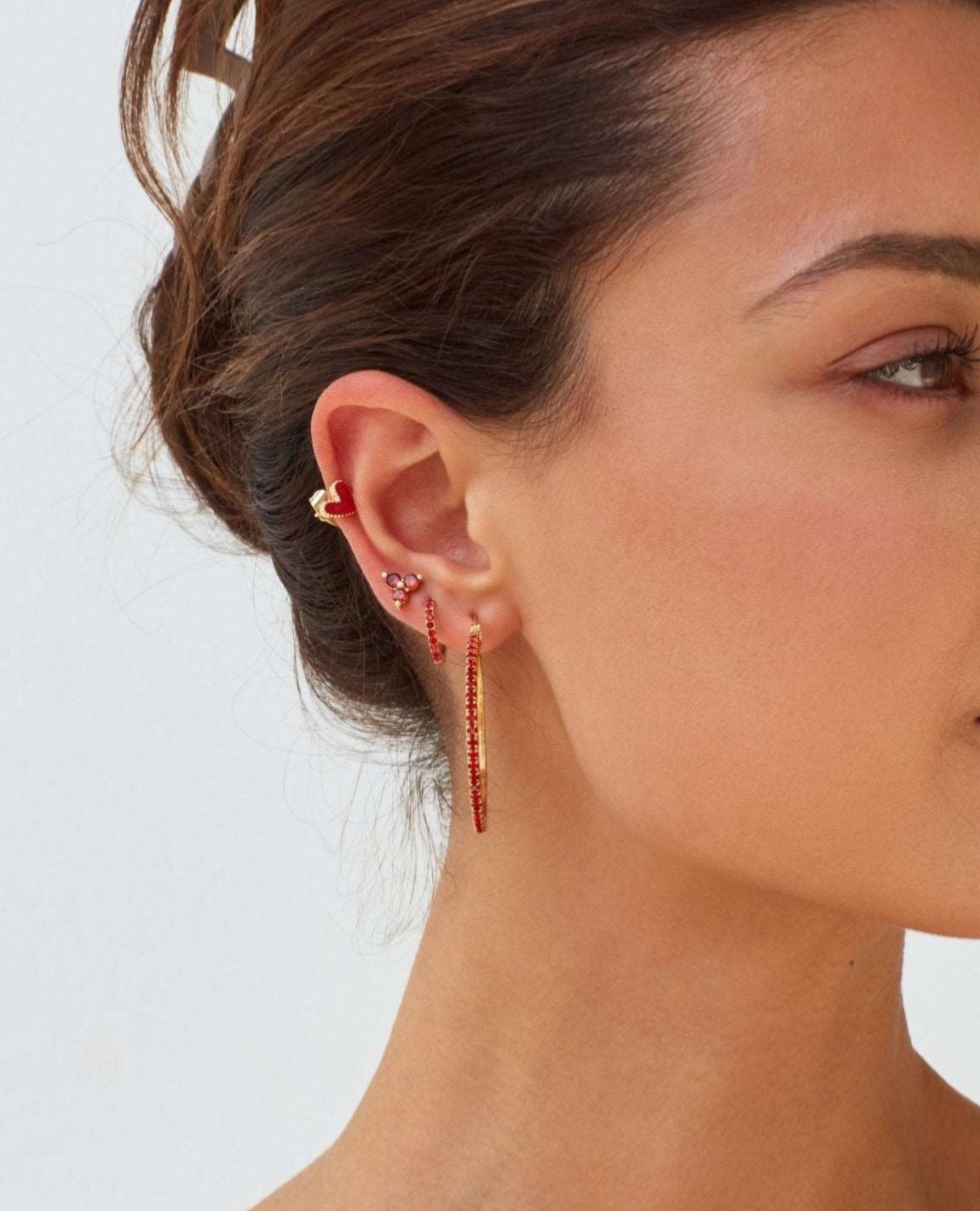 Model wearing red heart earrings 